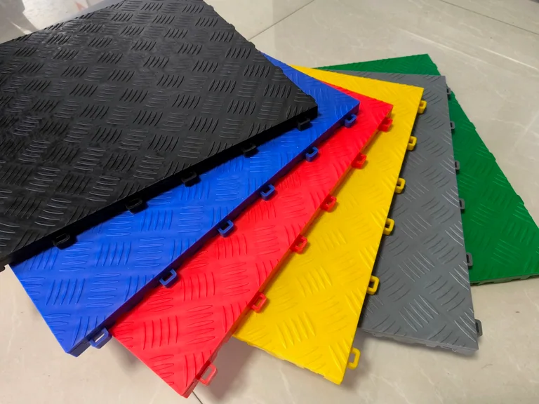 Fanned stack of garage tiles in black, blue, red, yellow, grey, and green